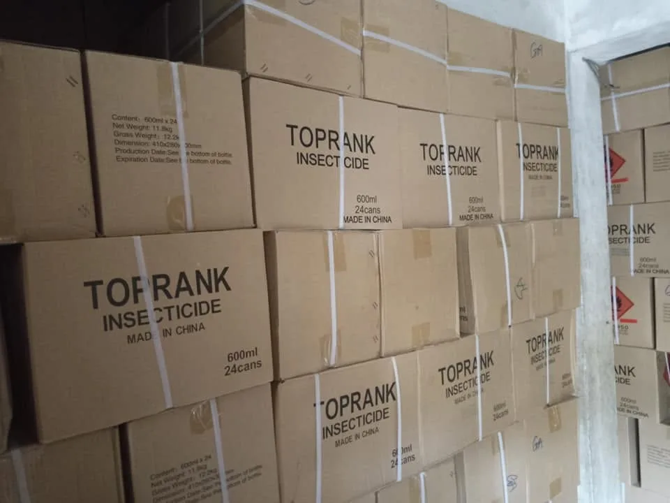 Cartons of TOPRANK insecticide stacked in the C-Success store.